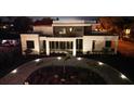 Night view of a contemporary home with landscaped yard and lighting at 2110 Michele Dr, Sarasota, FL 34231