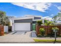 Contemporary house with a green accent gate and modern wooden fence at 2254 Hawthorne St, Sarasota, FL 34239