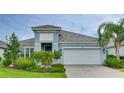 Two-story house with light blue exterior and white garage at 2582 Wild Cherry Path, Sarasota, FL 34240