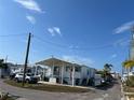 White single-wide home with teal accents and covered porch at 2601 Gulf N Dr # 427, Bradenton Beach, FL 34217