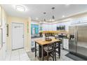 Modern kitchen with stainless steel appliances and an island at 3368 Ramblewood Pl # 37D1, Sarasota, FL 34237