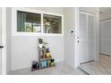 Light, airy entryway with tile flooring, neutral walls, and a charming plant stand at 3622 Bonaventure Ct, Sarasota, FL 34243