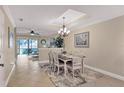 Bright dining room featuring a farmhouse table and access to the living room at 4007 Overture Cir, Bradenton, FL 34209