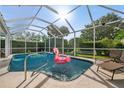 Relaxing screened-in pool area with lounge chairs and inflatable flamingo at 416 Giovanni Dr, Nokomis, FL 34275