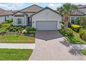 Single-story home with gray garage door and landscaped yard at 5361 Salcano St, Sarasota, FL 34238