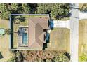 Aerial view of home with screened pool, fenced yard and long driveway in a quiet neighborhood setting at 5551 Allamanda Ave, North Port, FL 34288