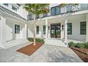 Elegant entryway with double doors and a paved walkway at 656 Tropical Cir, Sarasota, FL 34242