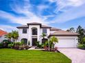 Two-story house featuring a white exterior, brown roof, and lush landscaping at 7724 Us Open Loop, Lakewood Ranch, FL 34202