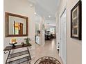 Neutral hallway showcasing elegant tile flooring, decorative mirror and tasteful decor at 8403 Grand Estuary Trl # 301, Bradenton, FL 34212