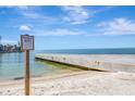 Private beach access for residents, with a sandy shore and pier at 9 Sandy Cove Rd # 8A, Sarasota, FL 34242