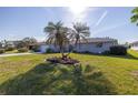 Front yard view, showing a house with palm trees at 1006 Pine Forest Ct, Venice, FL 34293