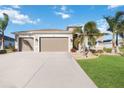 Attractive home with a three-car garage and manicured lawn at 12822 Rainwashed Loop, Parrish, FL 34219