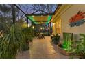 Large screened patio with a fountain, greenery and comfortable lighting at 1359 Tearose Pl, Sarasota, FL 34239