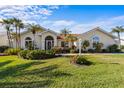 Single-story home with tile roof, lush landscaping, and a large front yard at 1441 Gleneagles Dr, Venice, FL 34292