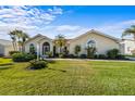 Single-story home with tile roof, lush landscaping, and a large front yard at 1441 Gleneagles Dr, Venice, FL 34292