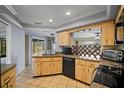 Kitchen with light wood cabinets, stainless steel appliances, and a large sink at 157 Da Vinci Dr, Nokomis, FL 34275