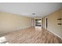 Bright living room with wood-look floors and multiple windows at 157 Da Vinci Dr, Nokomis, FL 34275