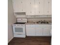 Bright kitchen featuring white cabinetry, a stainless steel sink, and an electric range at 1711 41St S St, St Petersburg, FL 33711