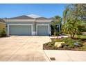 Two-story house with a three-car garage and a large driveway at 2006 Red Lake Run, Bradenton, FL 34211