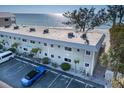 Aerial view of a beachfront multi-Gathering building with parking and beautiful landscaping at 2310 Gulf N Dr # 201, Bradenton Beach, FL 34217