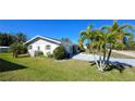 View of the house's side, showcasing the garage and landscaping at 2701 Larkspur Dr, Punta Gorda, FL 33950