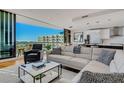 Bright living room with a modern kitchen, couch, and a balcony offering beautiful city views at 300 S Pineapple Ave # 802, Sarasota, FL 34236