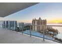 Enjoy breathtaking sunset views from this spacious balcony, featuring modern glass railings and stunning ocean vistas at 301 Quay Commons # 1411, Sarasota, FL 34236