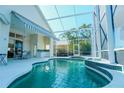 A luxurious screened-in pool area with a spa, covered patio, and plenty of space for outdoor entertaining at 308 Bermuda Ct # 13, Venice, FL 34293