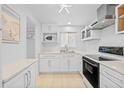 This renovated kitchen features modern appliances, white cabinetry, and stainless steel accents at 4126 Heron Way # B113, Bradenton, FL 34205