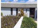 Charming home's exterior featuring a well-manicured lawn, tidy garden beds, and a neutral-colored facade at 4160 Fruitville Rd # 32, Sarasota, FL 34232