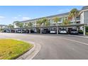 Condo building with covered parking and landscaping at 4320 Falmouth Dr # 301, Longboat Key, FL 34228