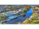 Aerial view of the property showcasing its waterfront location, pool, and proximity to the canal at 4607 Mangrove Point Rd, Bradenton, FL 34210