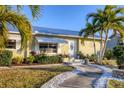 Lovely front entrance with beautiful landscaping, decorative stones, and an inviting doorway at 4607 Mangrove Point Rd, Bradenton, FL 34210