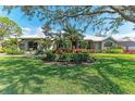 Charming home featuring beautiful landscaping, mature trees, and a well-manicured lawn at 4749 Antler Trl, Sarasota, FL 34238