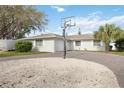 A well-maintained house with a white garage door and a brick driveway leading up to the front door at 4925 Silk Oak Dr, Sarasota, FL 34232