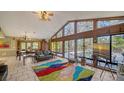 Spacious living room with high ceilings, a colorful rug, and pool view at 5180 Meldon Cir, Sarasota, FL 34232