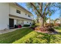 Charming condo with manicured lawn, mature tree, and flowerbeds at 527 Sutton Pl # T-12, Longboat Key, FL 34228