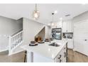 Modern kitchen island with white quartz countertop and stainless steel sink at 5703 Tripoli Dr, Palmetto, FL 34221