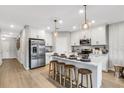 Modern kitchen with white cabinets, island, and stainless steel appliances at 5703 Tripoli Dr, Palmetto, FL 34221