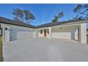 Two-car garage with white doors and a long driveway at 5923 22Nd Avenue E Dr, Palmetto, FL 34221