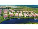 Community aerial view showcasing waterfront properties and lush greenery at 6063 Benevento Dr, Sarasota, FL 34238