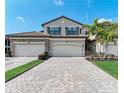 Two-story home with a two-car garage and paver driveway at 6086 Worsham Ln # 102, Bradenton, FL 34211