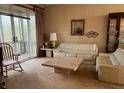 Living room with beige walls, off-white couches, and a large stone coffee table at 611 Cedars Ct, Longboat Key, FL 34228