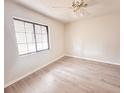 Bright bedroom with wood-look floors and a large window at 613 Chevy Chase Dr, Sarasota, FL 34243