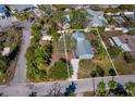 Aerial view showcasing a charming light blue single story home nestled within a residential area at 651 Fox St, Longboat Key, FL 34228