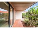 Condo entryway with sliding glass door and terracotta tile flooring at 6666 Draw Ln # 132, Sarasota, FL 34238