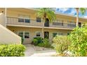 Exterior view of condo building with mature landscaping and welcoming entrance at 6939 W Country Club N Dr # 158, Sarasota, FL 34243