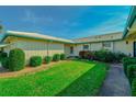 Neatly landscaped yard with a walkway leading to the house entrance at 7003 9Th W Ave, Bradenton, FL 34209