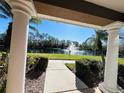 View of a pond with fountain from covered walkway at 7615 River Oak Run # 103, Lakewood Ranch, FL 34202