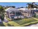 Aerial view of a screened-in pool area with outdoor seating and a well-maintained backyard at 8729 52Nd E Dr, Bradenton, FL 34211